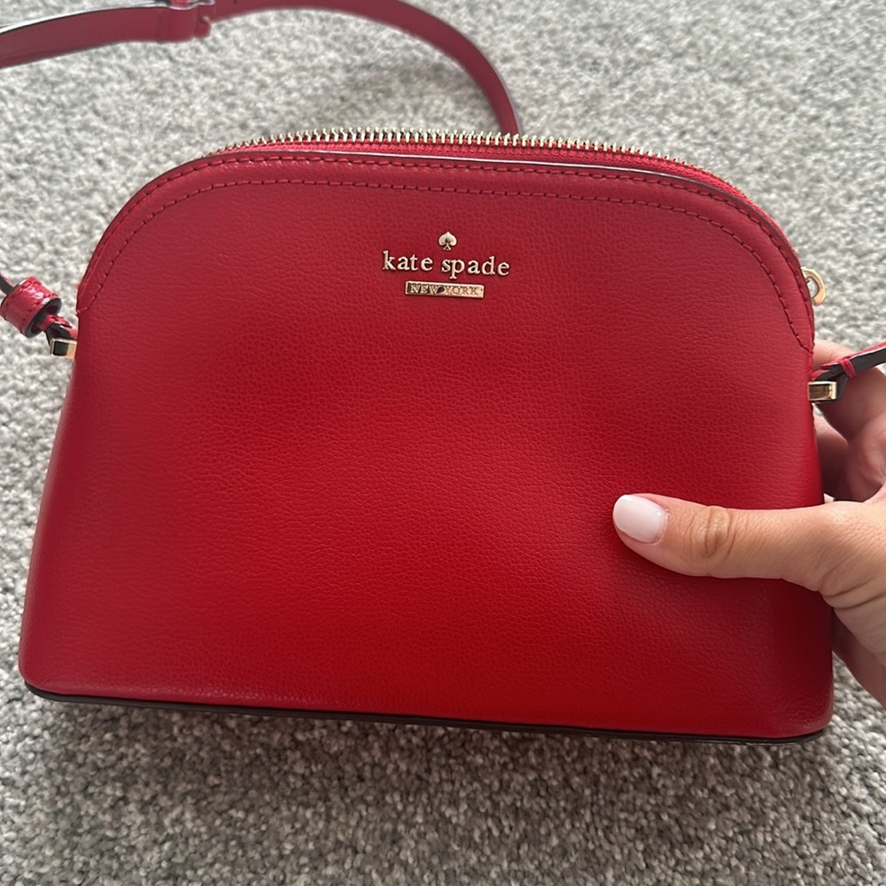 Red Kate Spade crossbody purse.